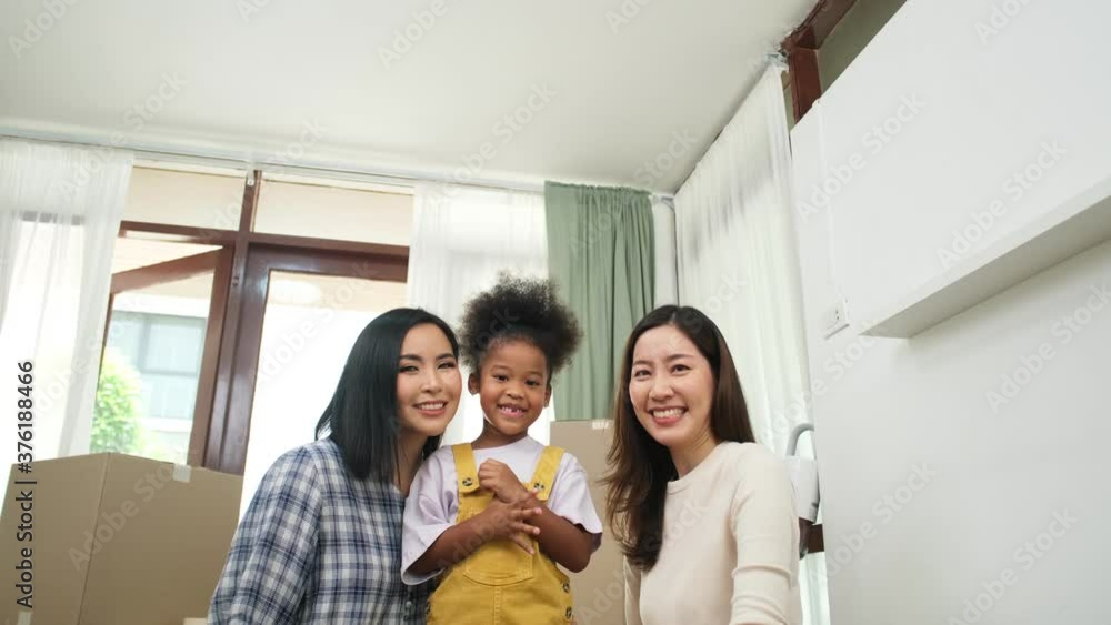 Happy asian women LGBT lesbian couple holding boxes entering new modern house.family unpacking boxes. Happy asian women LGBT lesbian couple holding boxes entering new modern house.family unpacking boxes.