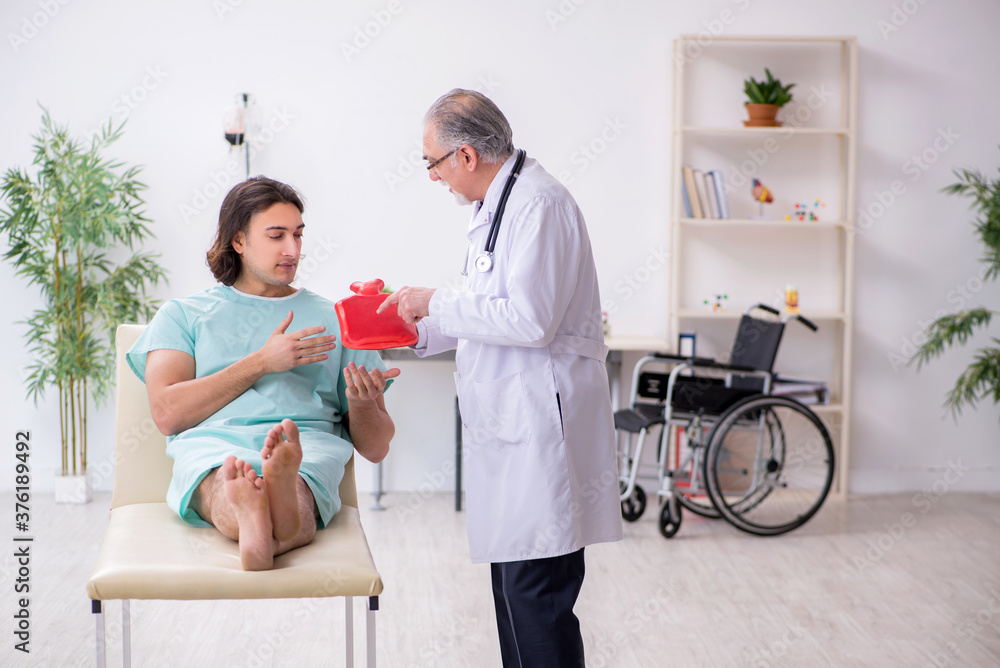 Fototapeta premium Young male patient visiting experienced doctor gastroenterologist