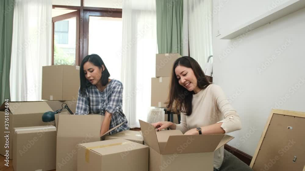 Happy asian women LGBT lesbian couple holding boxes entering new modern house.family unpacking boxes. Happy asian women LGBT lesbian couple holding boxes entering new modern house.family unpacking boxes.
