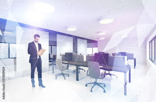 Businessman with clipboard in modern office © ImageFlow