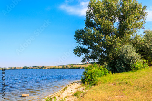 Summer landscape with beautiful river, green trees and blue sky