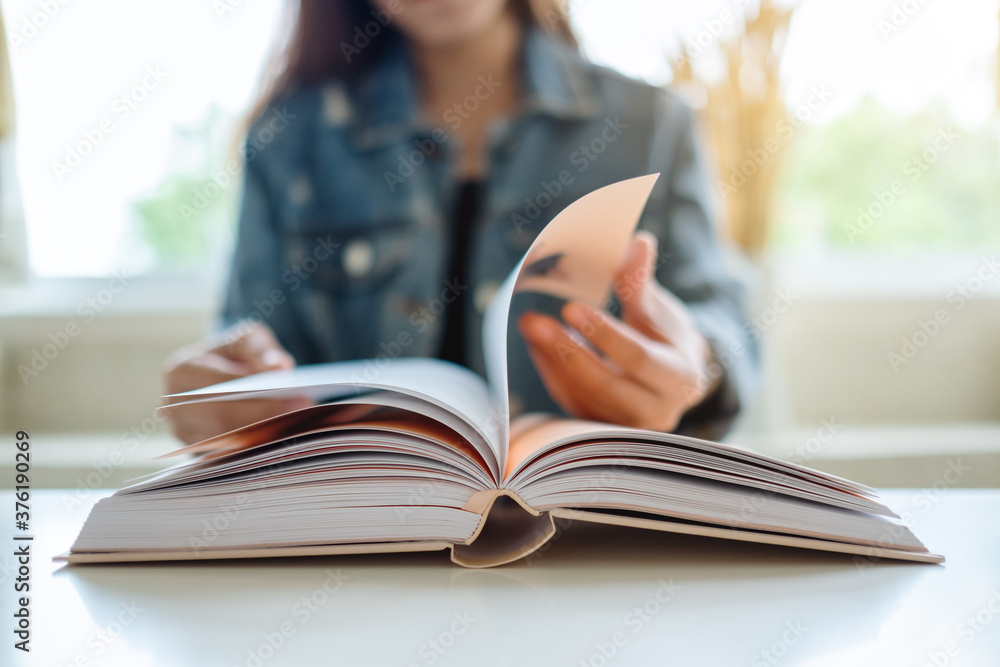 Closeup image of a woman sitting and reading book Closeup image of a woman sitting and reading book