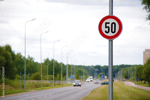 speed limit sign and road on background