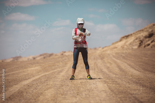 Fitness woman trail runner cross country running  on sand desert dunes