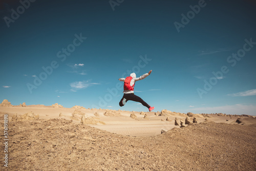 Woman trail runner cross country running on sand desert dunes