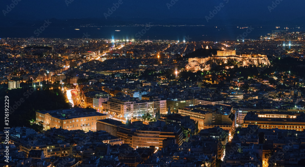 Night view of Athens and Acropolis with Parthenon, Hellenic Parliament and ruins of temple of Zeus. Famous iconic view of UNESCO world heritage site.