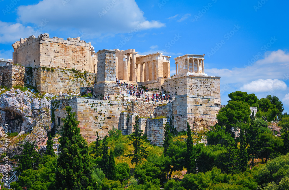 View of Acropolis hill from Areopagus hill on summer day with great clouds in blue sky, Athens, Greece. UNESCO world heritage. Propylaea, Parthenon.