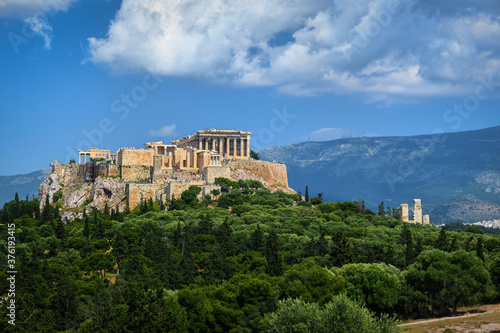 Great view of Acropolis hill from Pnyx hill on summer day with great clouds in blue sky, Athens, Greece. UNESCO world heritage. Propylaea, Parthenon. © NPershaj
