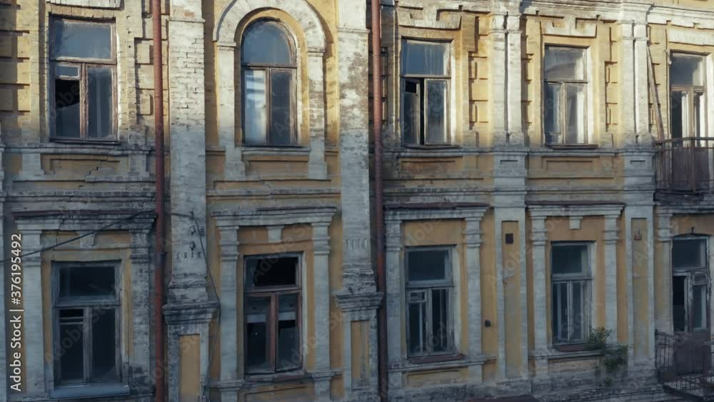 Abandoned old manor (mansion) house with broken windows. Deserted 19th century building. Aerial side view Abandoned old manor (mansion) house with broken windows. Deserted 19th century building. Aerial side view