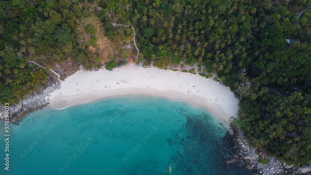 Aerial view. Top view of tropical island forest and white sand beach with turquoise sea water in Phuket. Freedom beach, Thailand