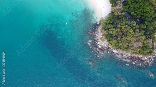 Aerial view. Top view of tropical island forest and white sand beach with turquoise sea water in Phuket. Thailand