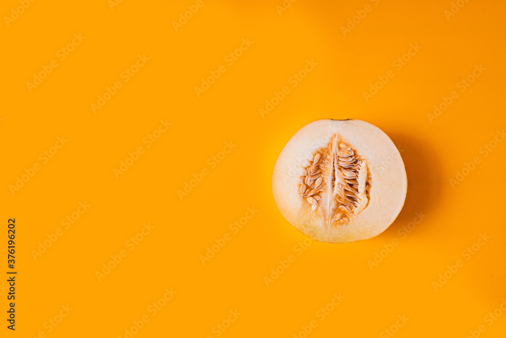 ripe yellow half of a melon on yellow background ripe yellow half of a melon on yellow background