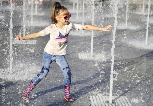 Little girl jumping in water.