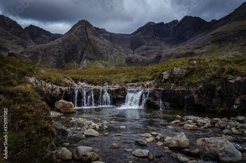 A waterfall in the Fairy Pools on the Isle of Skye under a stormy sky  Scotland  United Kingdom