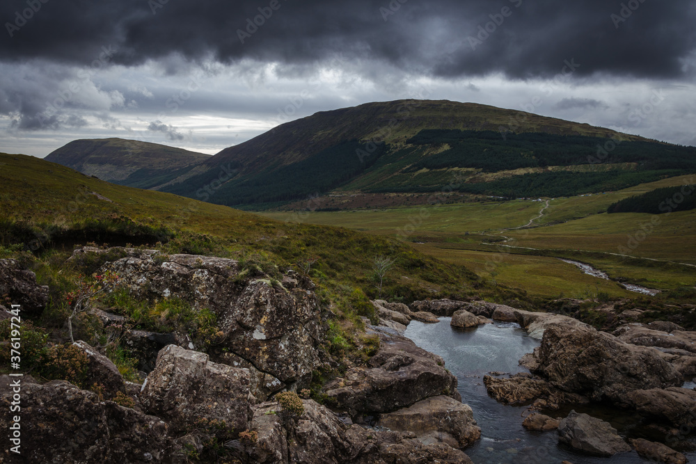 River in the Fairy Pools on the Isle of Skye under a stormy sky, Scotland, United Kingdom River in the Fairy Pools on the Isle of Skye under a stormy sky, Scotland, United Kingdom