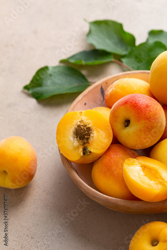 Close up of Raw ripe apricots in bowl on stone table