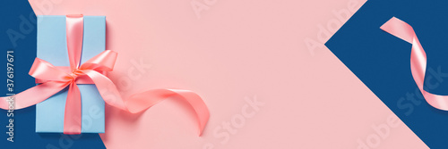 Web banner with blue gift box. Classic blue and pink background with space for the text.
