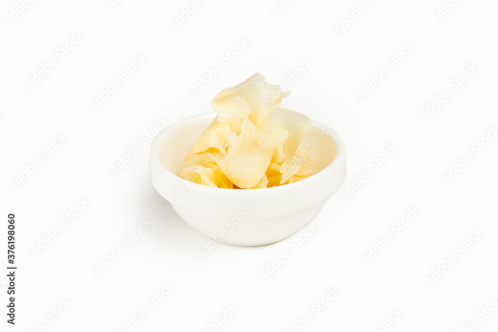 White ginger in a bowl on a white background. For the restaurant menu. Traditional Japanese sushi seasoning. Healthy eating