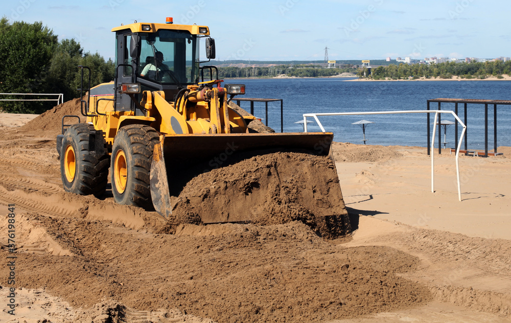 Obraz premium excavator at work on the sand beach