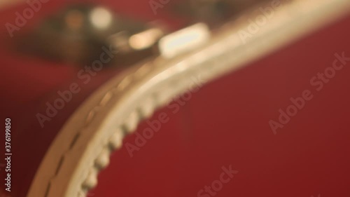 Super close up of an old vintage red briefcase. Camera pan with shallow depth of field. photo