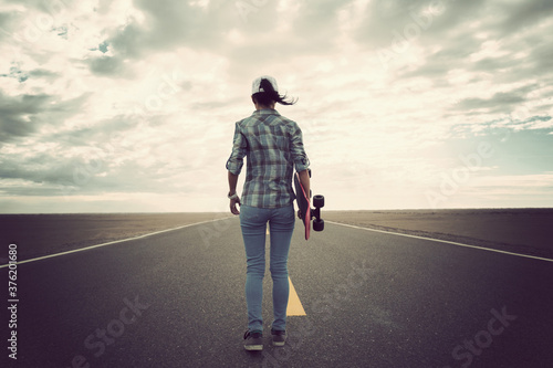 Asian woman skateboarder skateboarding in the wide world