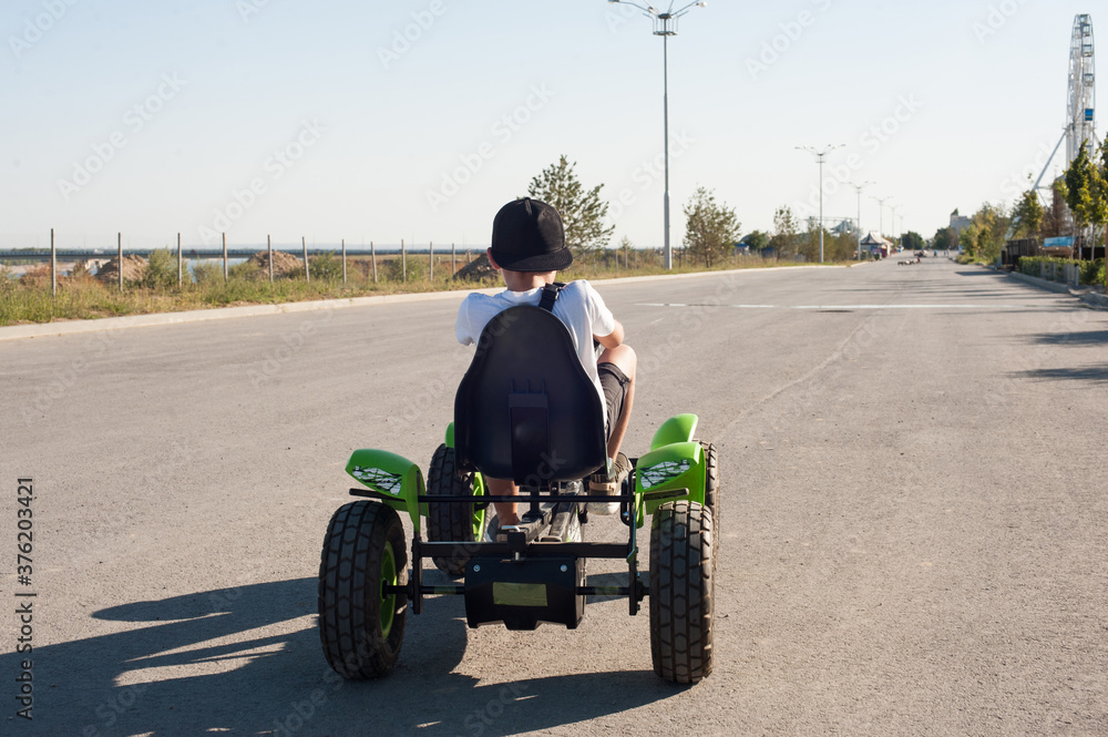 A boy rides a Bicycle in the Park in the summer A boy rides a Bicycle in the Park in the summer
