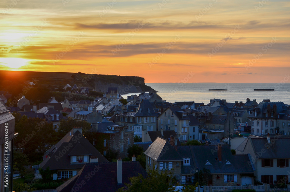 The town of Arromanches-les-Bains in Normandy on the coast of the English Channel at sunset, France, one of the allied landing places on D-Day (Gold Beach), panoramic view, a sunny evening in summer