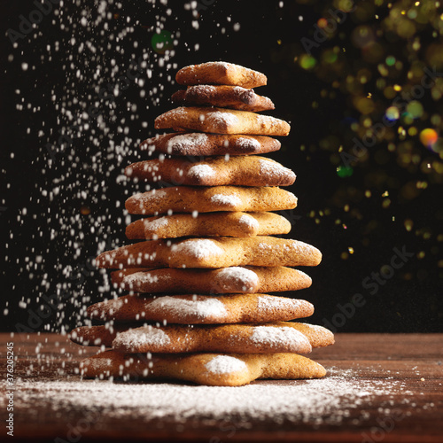 Christmas gingerbread cookies and spices on wooden background. Close-up