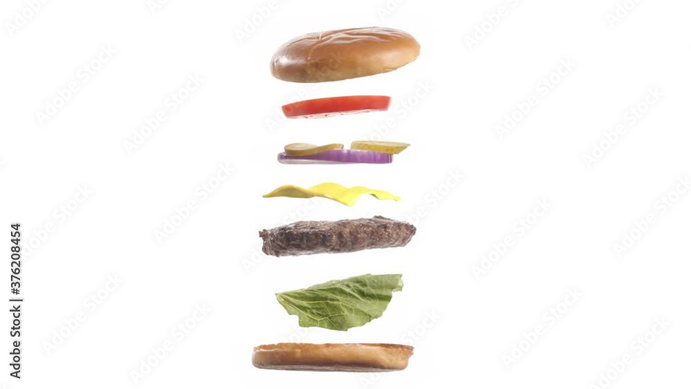 Big tasty burger with looping flying spinning ingredients on white background. Isolated. Endless