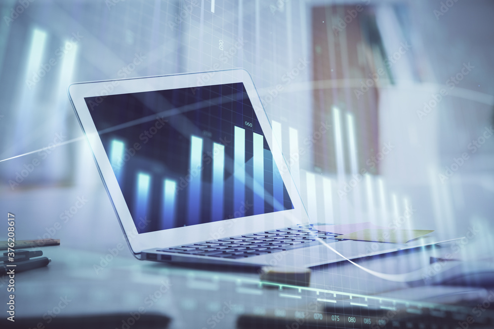 Forex graph hologram on table with computer background. Multi exposure. Concept of financial markets. Forex graph hologram on table with computer background. Multi exposure. Concept of financial markets.