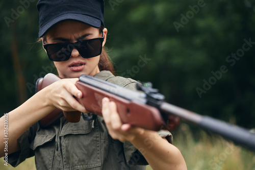 Woman Sunglasses weapon aiming green leaves green