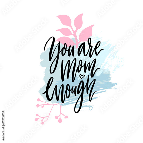 You are mom enough. Inspirational support quote about mathernity. Modern calligraphy on pink and blue texture with leaves sand branches