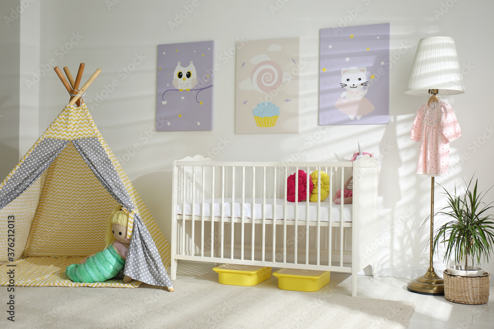 Baby room interior with cute posters, play tent and comfortable crib Baby room interior with cute posters, play tent and comfortable crib