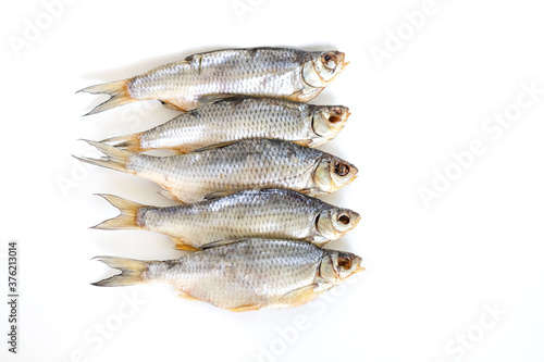 isolated close up top view dried salted caspian roach fish on a white background photo