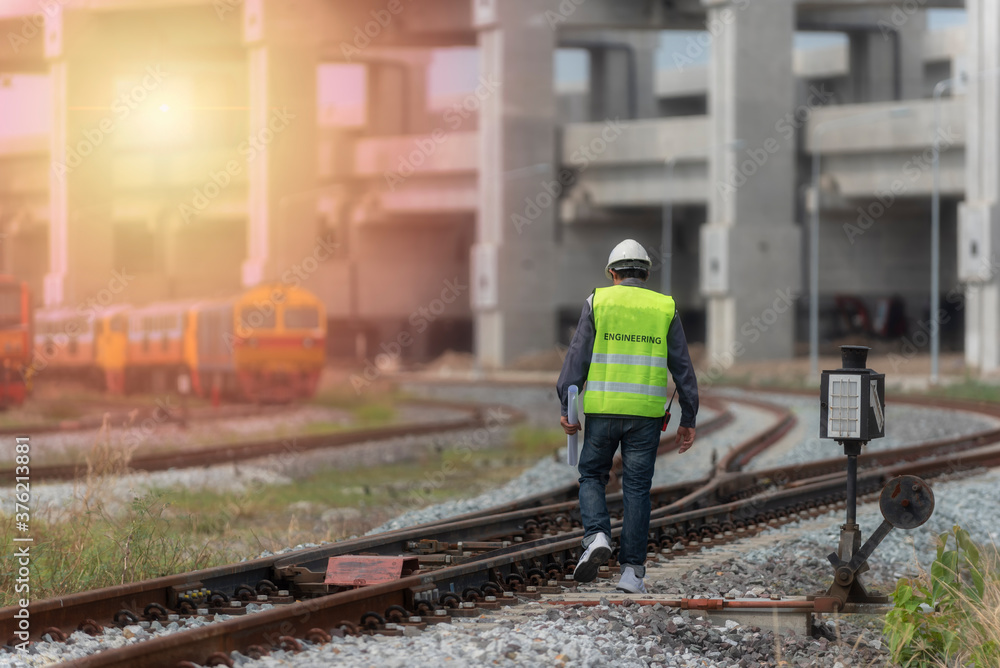 young man on railway.engineer walking and check track work on railways. people walk on railway . young man on railway.engineer walking and check track work on railways. people walk on railway .