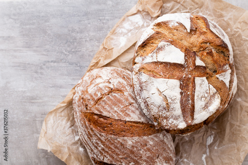 Assortment of baked bread on wooden table background. photo