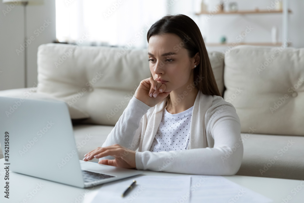 Confused unhappy young woman looking at computer screen, stressed about email with unexpected bad news. Frustrated lady received bad news notification, financial problems bankruptcy concept. Confused unhappy young woman looking at computer screen, stressed about email with unexpected bad news. Frustrated lady received bad news notification, financial problems bankruptcy concept.