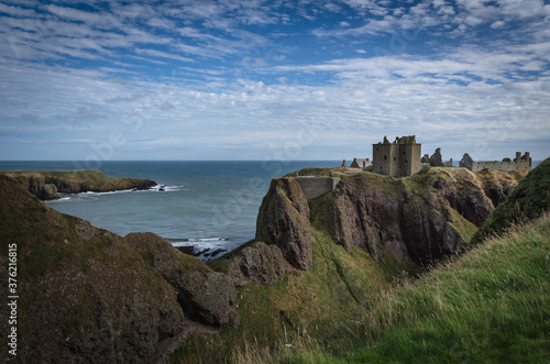 Dunnottar Castle on top of a cliff by the sea on a cloudy day, Stonehaven, Scotland, United Kingdom