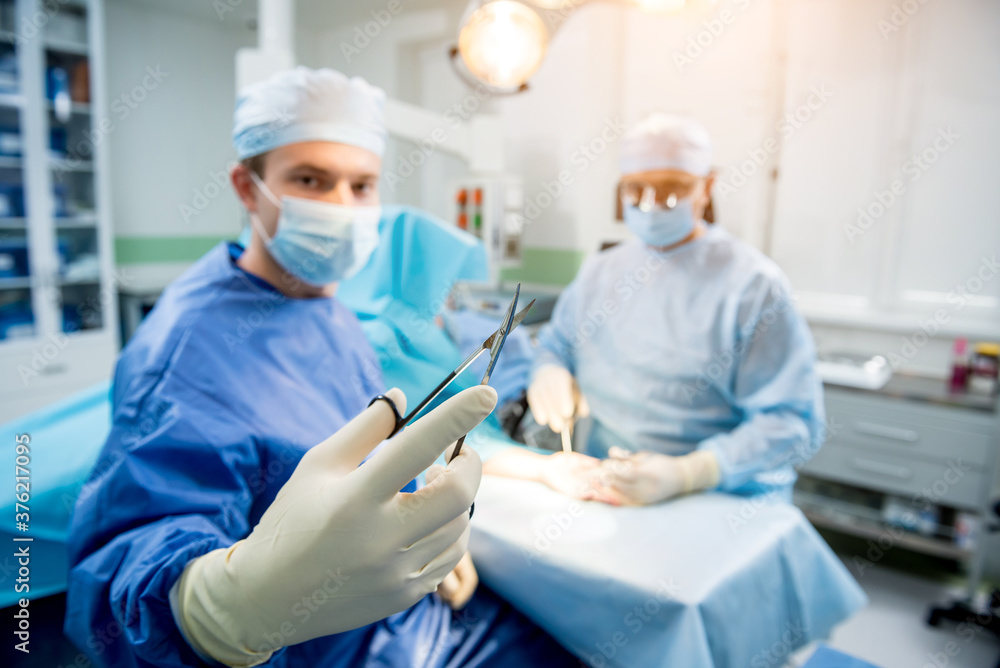 Surgeons in the operating room trying to save the patient's hand. Surgeons in the operating room trying to save the patient's hand.
