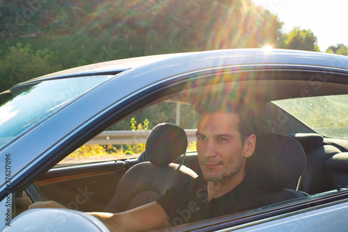 A handsome and cool man driving a car