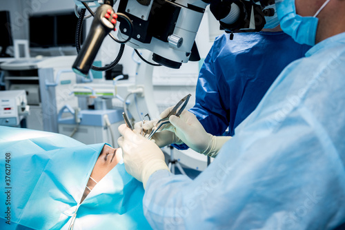 A team of surgeons performing brain surgery to remove a tumor. photo