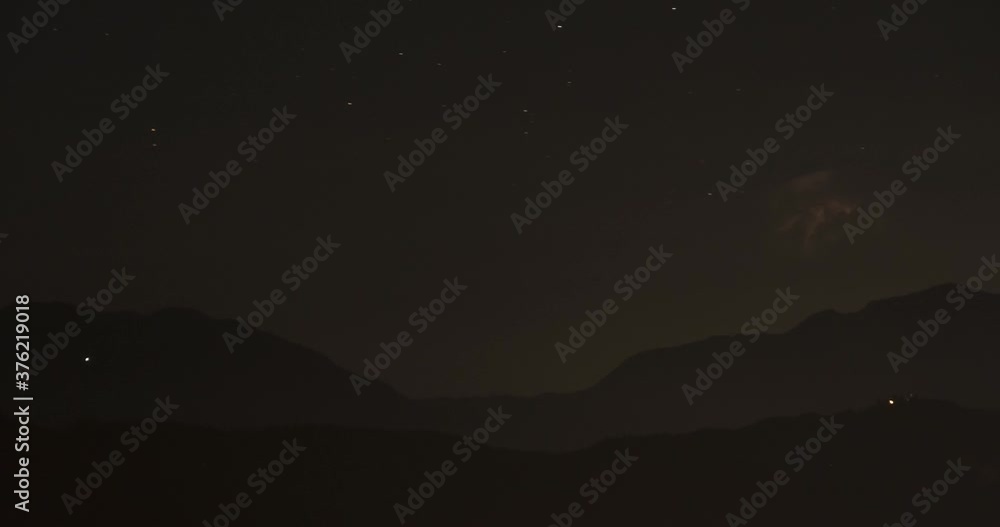 Time lapse of summer storm in the distance at night. Alps mountain range in foreground. The storm was 200 kilometers (124 miles) away. Static shot, long lens Time lapse of summer storm in the distance at night. Alps mountain range in foreground. The storm was 200 kilometers (124 miles) away. Static shot, long lens