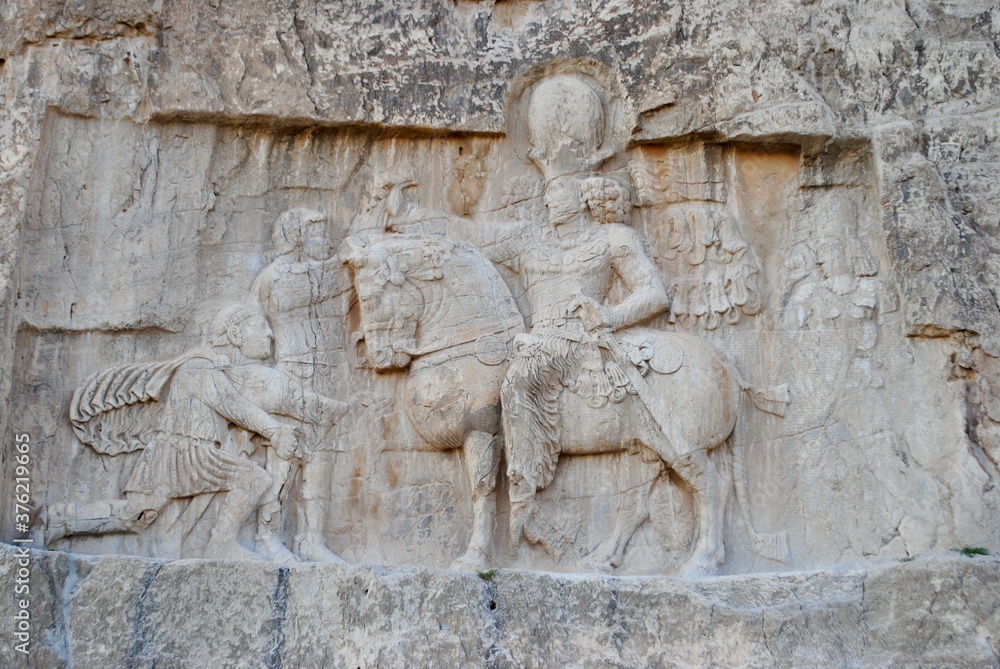 Rock reliefs at Naqsh-e Rustam. Roman Emperor Valerian yields himself to the Persian king Shapur (241-272 AD). Achaemenid and Sassanid periods. UNESCO World Heritage Site. Persepolis Iran.