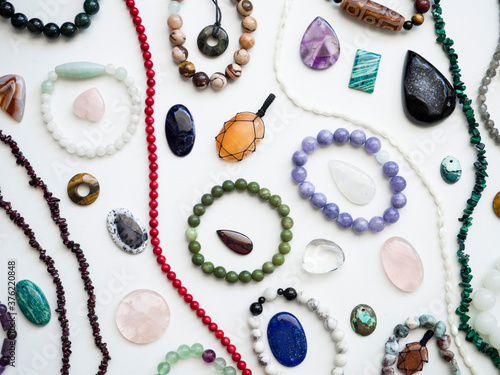 Multicolored semi-precious minerals, bracelets and pendants made of natural stones