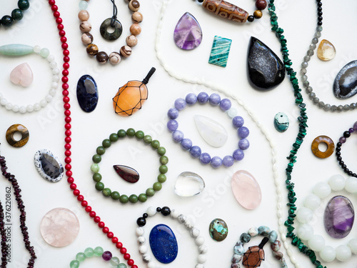 Multicolored semi-precious stones on a white background photo