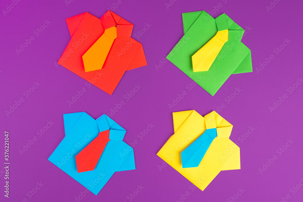 The concept of teamwork. Symbolic origami business suits in different colors. Combining different people into a team. Selection of the best specialists. Effectiveness of joint activities. The concept of teamwork. Symbolic origami business suits in different colors. Combining different people into a team. Selection of the best specialists. Effectiveness of joint activities.