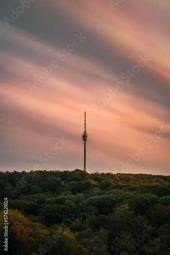 Stuttgart Television Tower (Fernsehturm) against sunset sky wit fast moving clouds, Germany