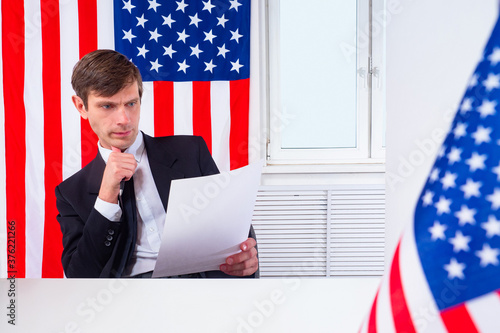 A man studies documents aga...