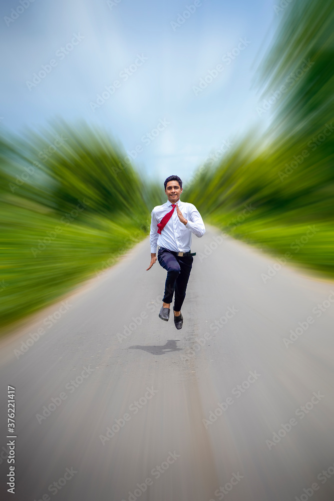 Young asian / Indian boy running on the road Young asian / Indian boy running on the road