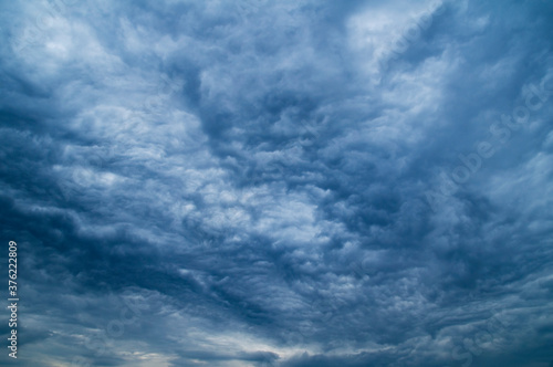 Dramatic dark blue sky with heavy clouds background